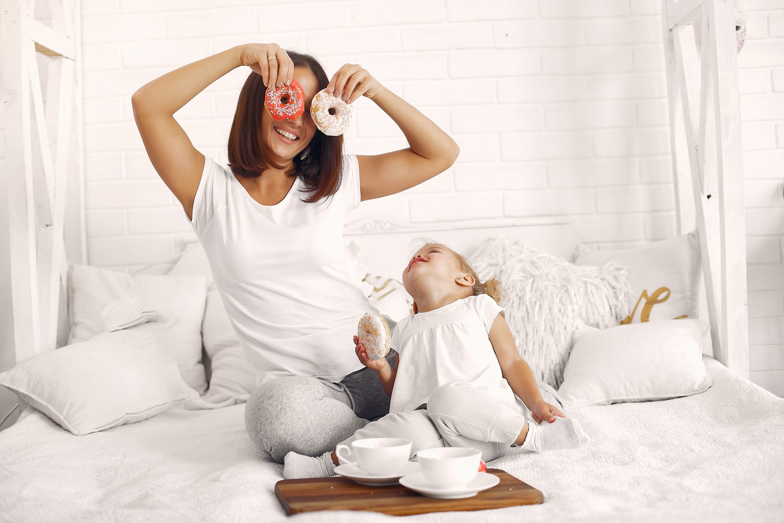 Mother and little daughter have a breakfast at home