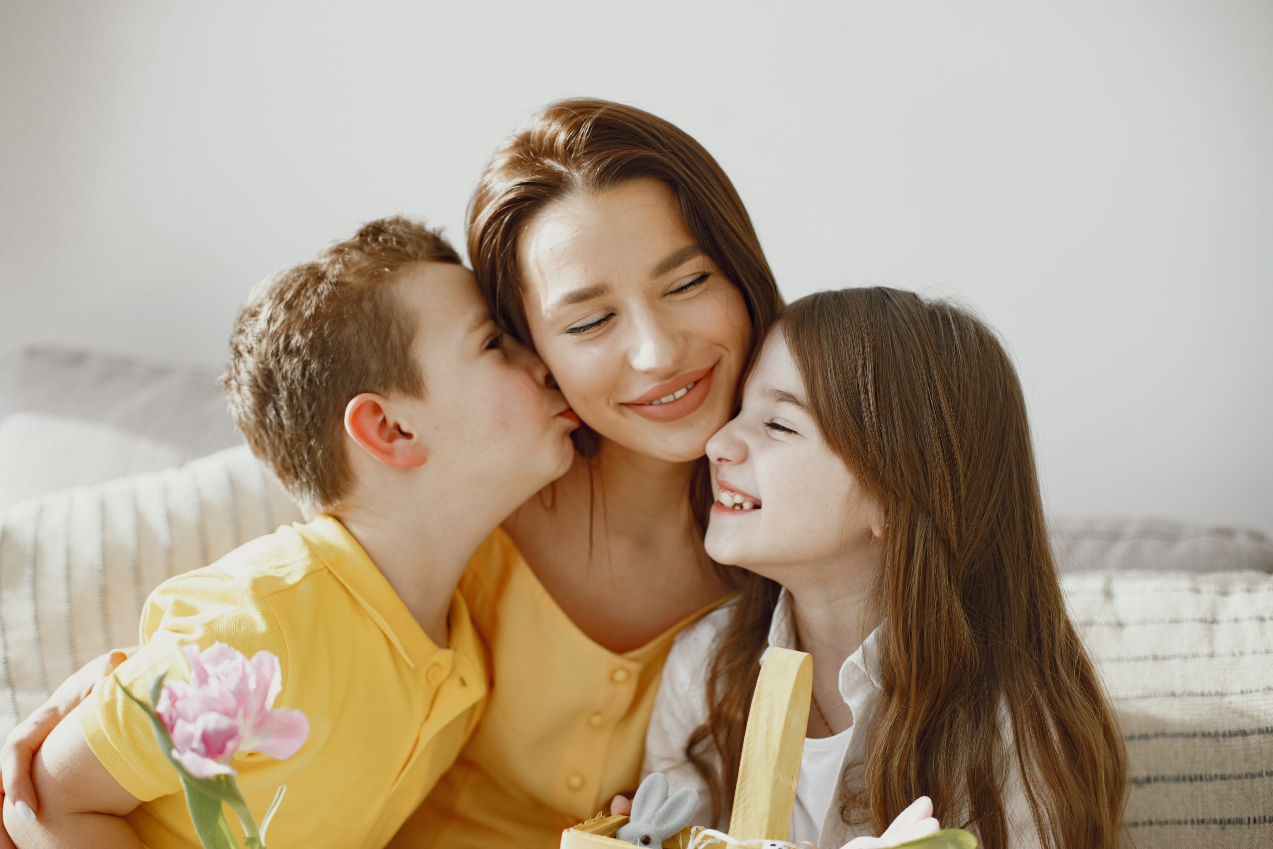 Family preparing for Easter celebration at home on sofa in yello